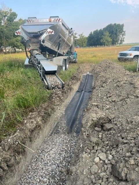 Hydrovac excavating a hole beside a house foundation