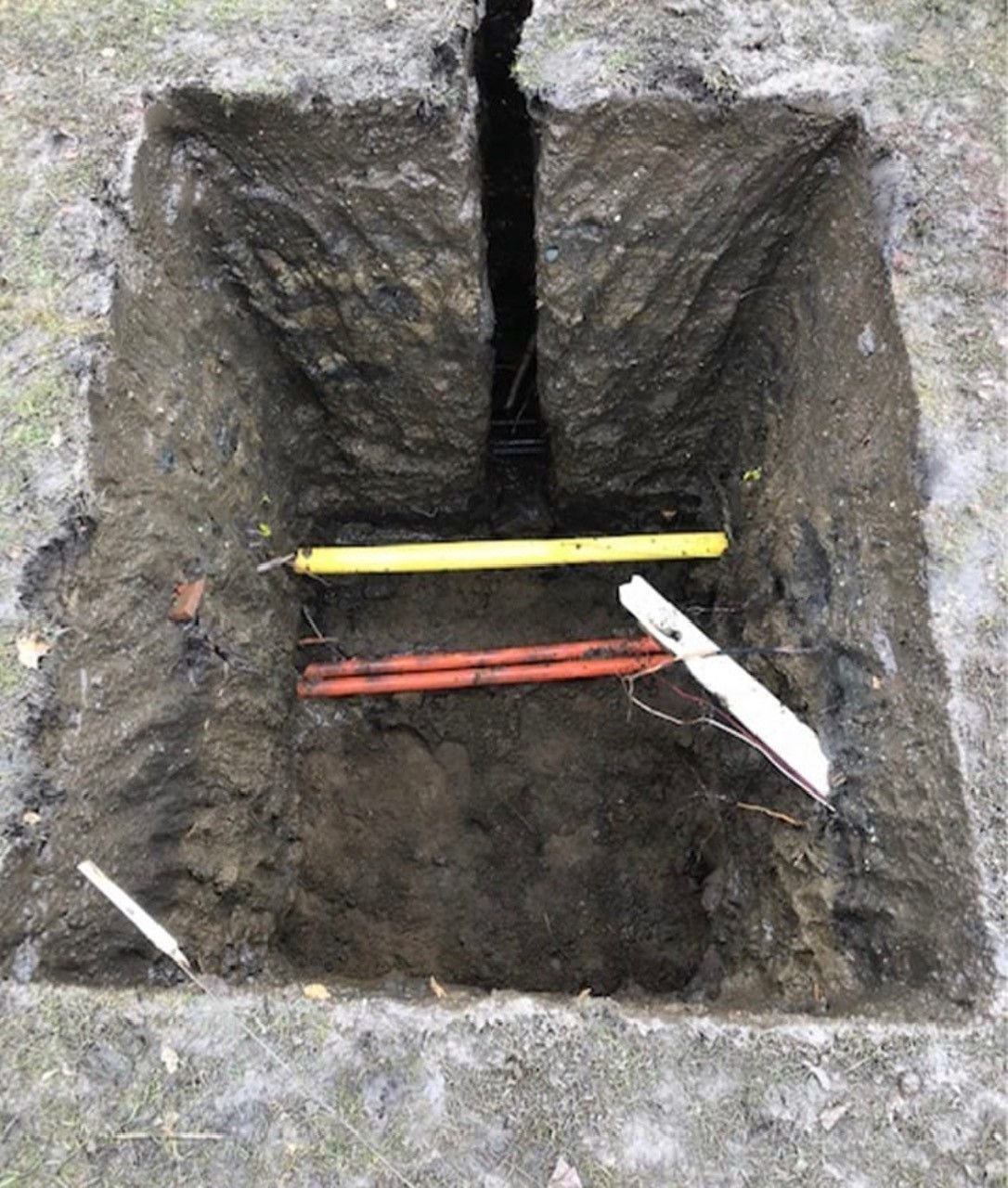 Exposed underground utility pipe after hydrovac daylighting